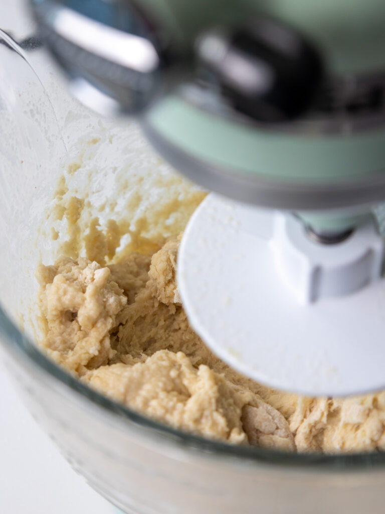 image of cinnamon roll dough being mixed in a stand mixer
