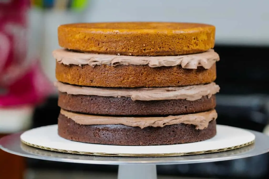 image of ombre chocolate cake layers stacked and ready to be crumb coated