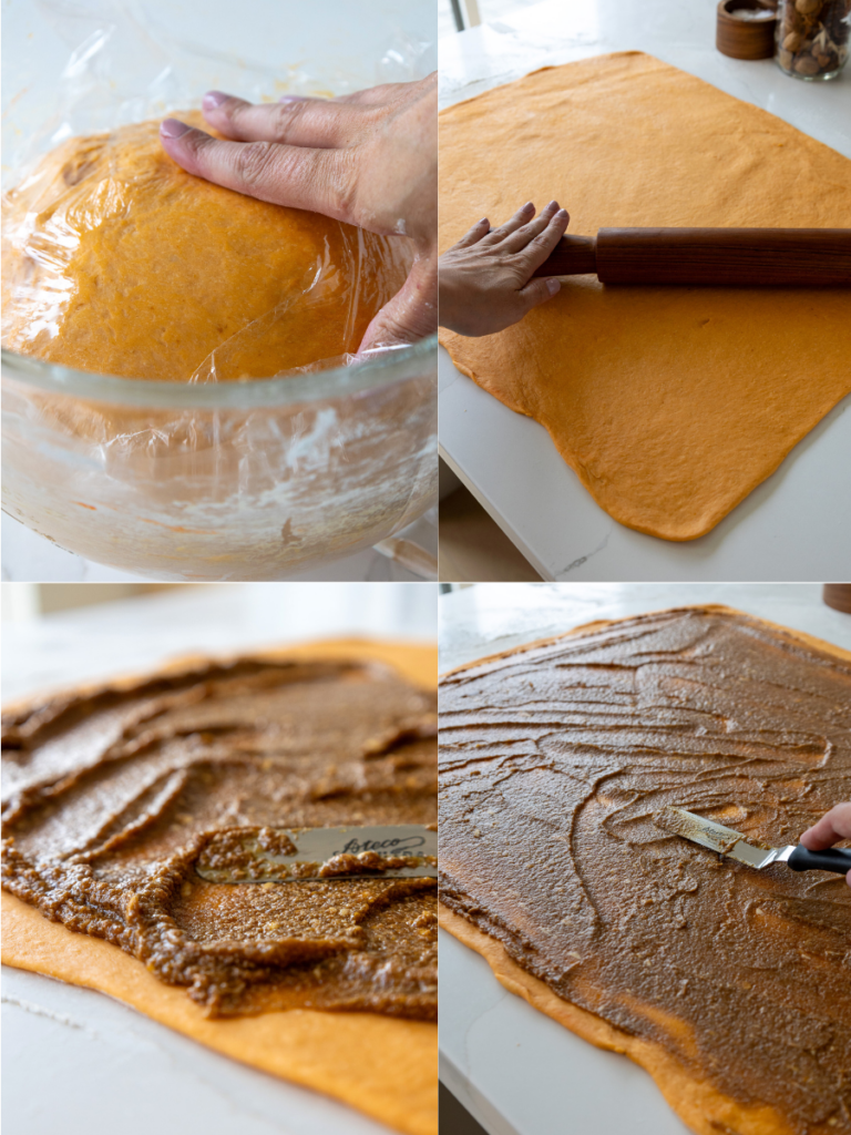 image of pumpkin cinnamon roll dough being rolled out and filled