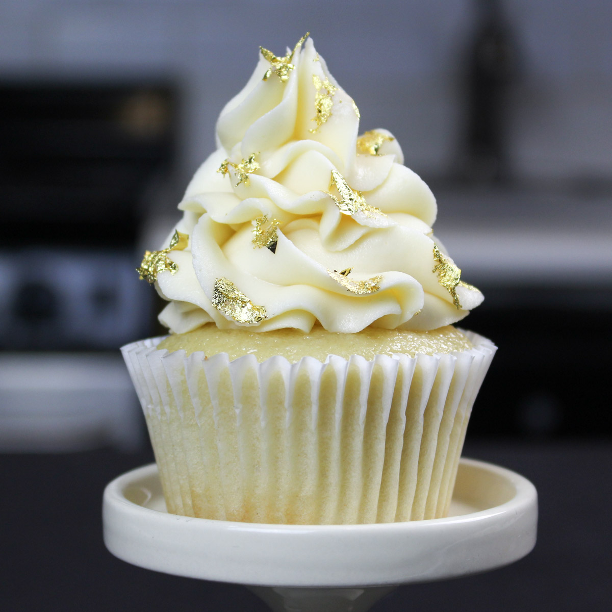 image of vanilla cupcake decorated with edible gold leaf