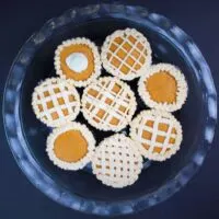 photo of the cutest pumpkin pie cupcakes, decorated with buttercream frosting to look like pie crust