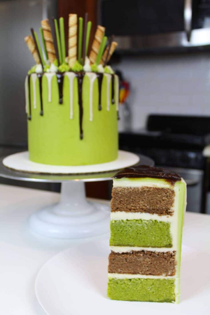 Sliced matcha cake decorate with a chocolate drip