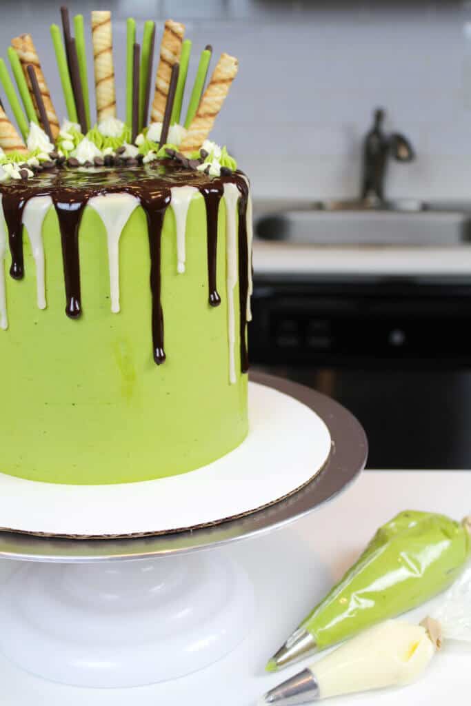 decorated matcha and chocolate layer cake, with chocolate drips