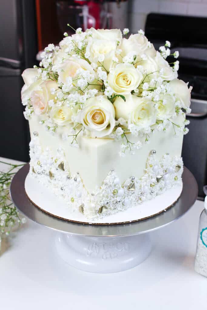 photo of square engagement cake decorated with fresh flowers