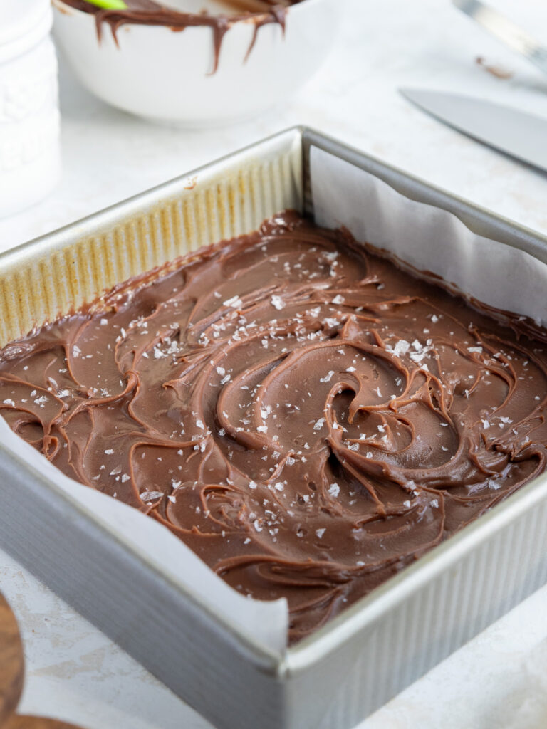 image of finished millionaire bars that have been sprinkled with sea salt and are ready to be removed from the pan and cut