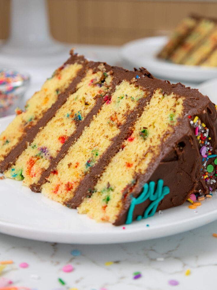 a slice of yellow layer cake on a plate