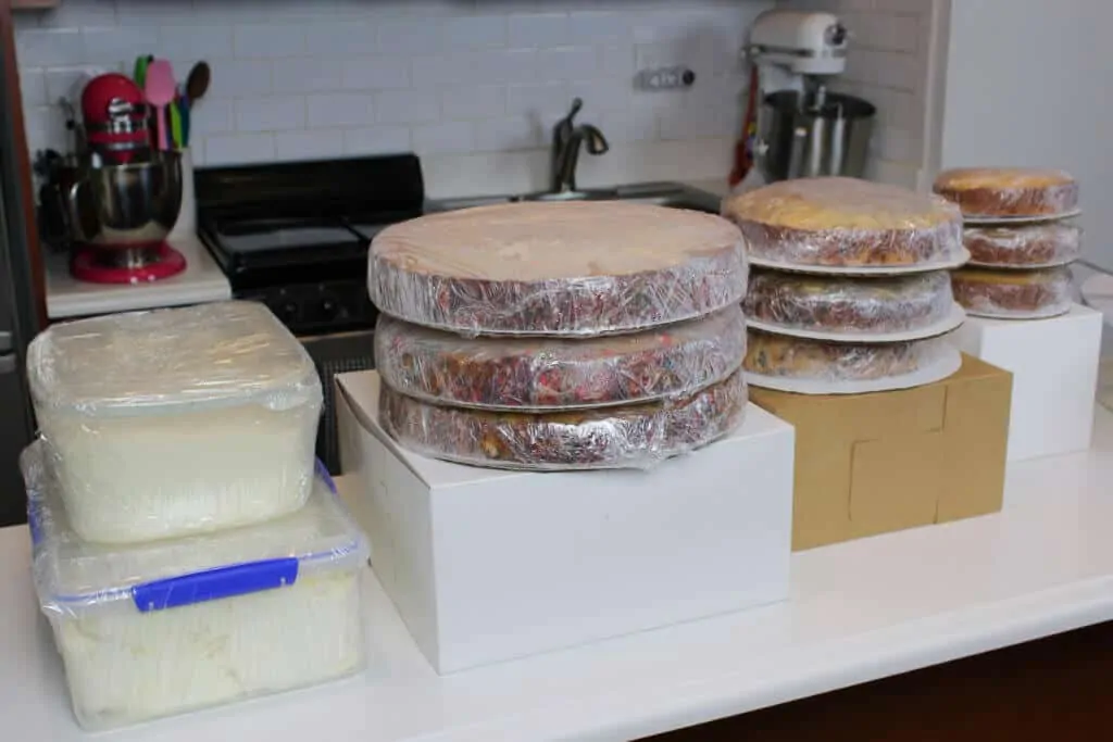 photo of wedding cake layers and frosting, prepped and wrapped for travel