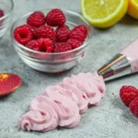 image of raspberry buttercream frosting piped out using a wilton 1m tip to show how easy it is to pipe with