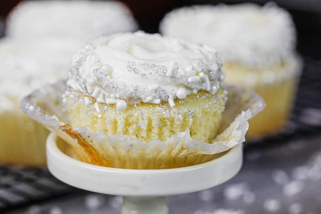 image of pretty almond cupcake unwrapped and ready to be eaten