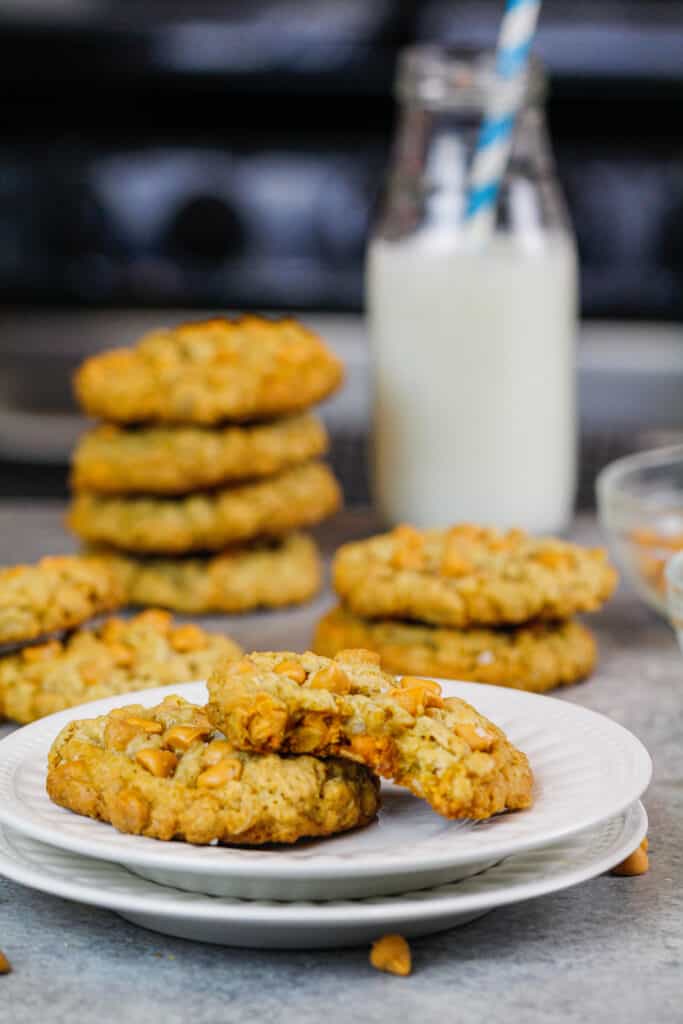 image of oatmeal scotchies on a plate with one cookie bitten into to show how soft and chewy the cookies are