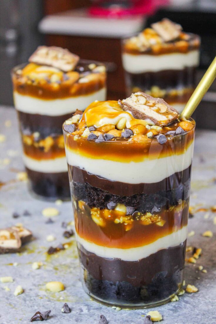 image of snickers trifles made in individual glasses to make them easy to serve and eat
