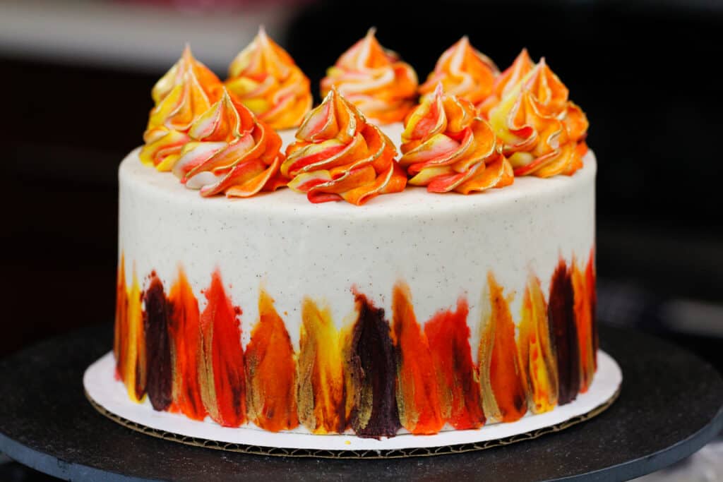 image of a beautiful gluten free spice cake decorated with bright Fall-inspired frosting