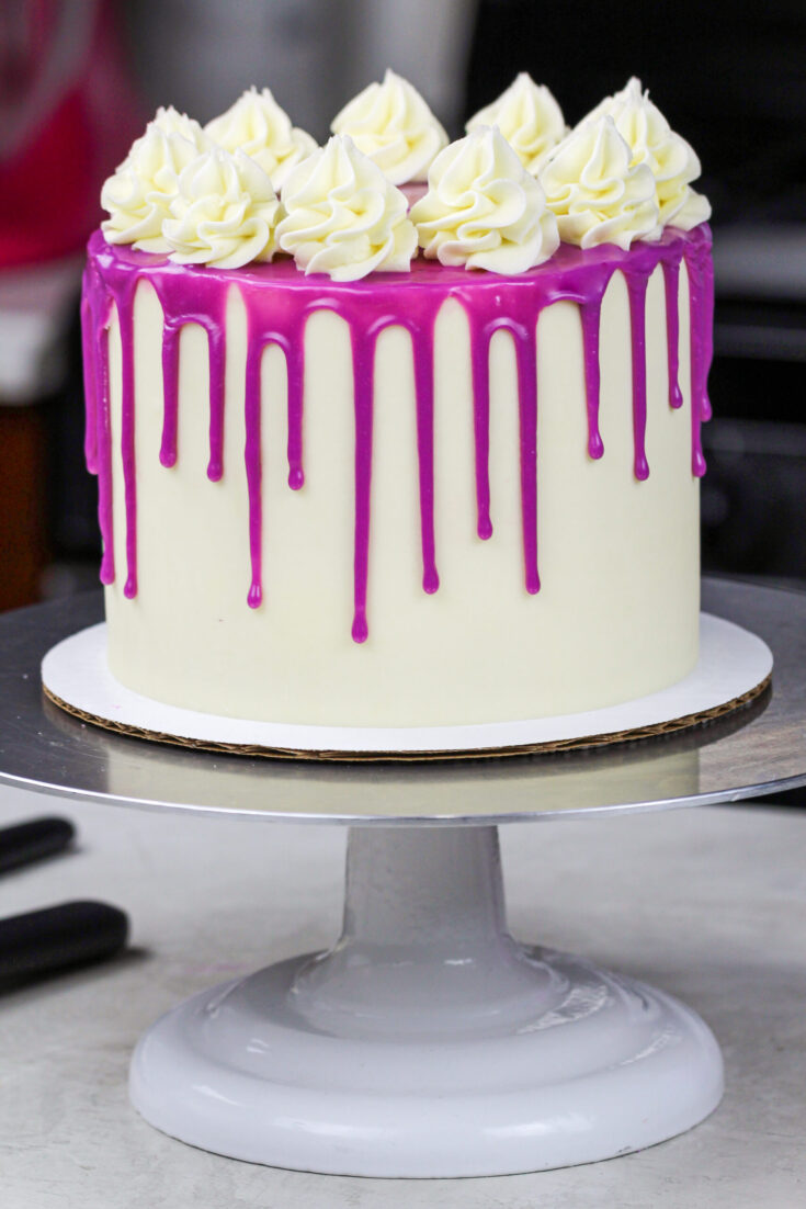 image of a purple drip cake made with a colorful white chocolate ganache