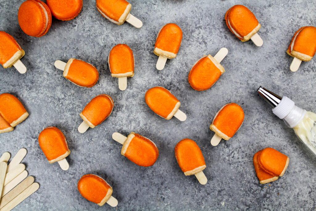 image of mini orange creamsicle macarons filled with orange creamsicle buttercream