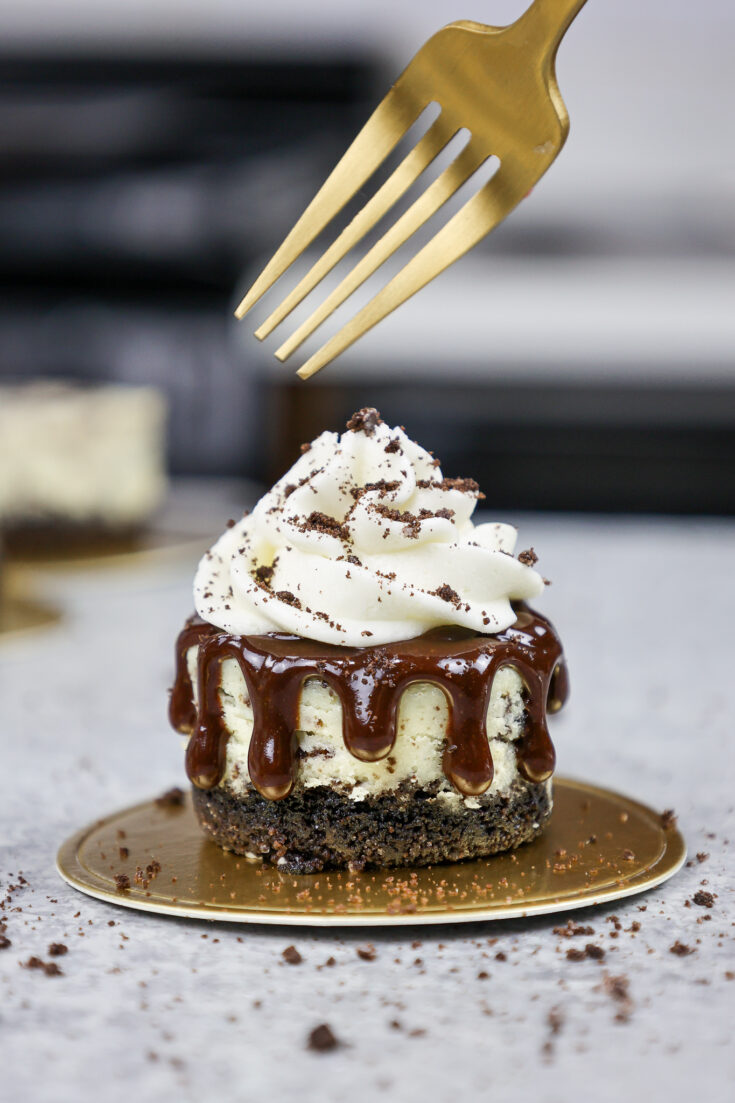 image of a mini oreo cheesecake topped with whipped cream and crushed oreos