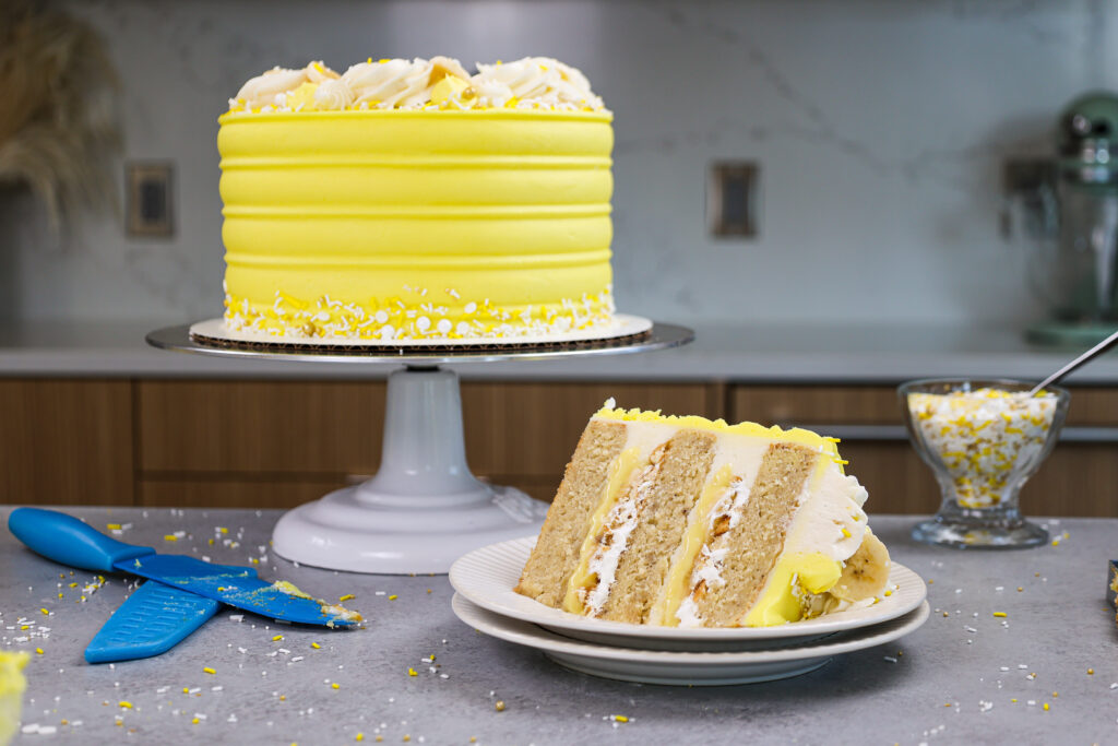 image of a banana pudding layer cake that's been cut into to show it's delicious banana pudding filling
