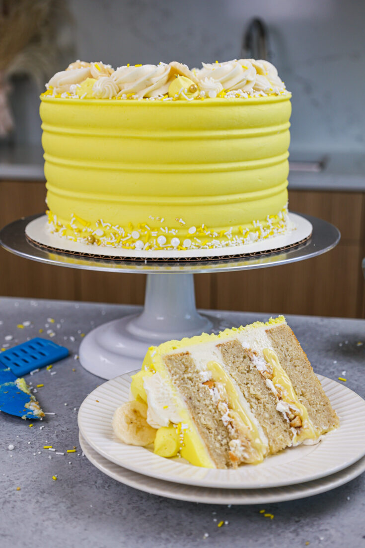 image of a banana pudding layer cake that's been cut into to show it's delicious banana pudding filling