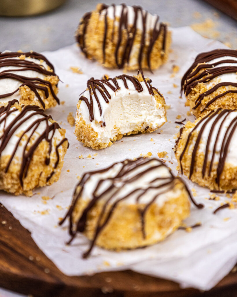 image of a creamy and delicious no bake cheesecake bite that's been bitten into to show it's incredible texture