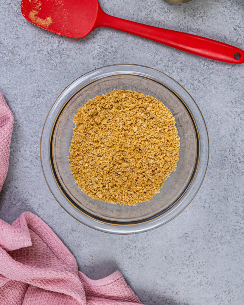 image of a graham cracker and butter mixture that's been made to garnish no bake cheesecake bites
