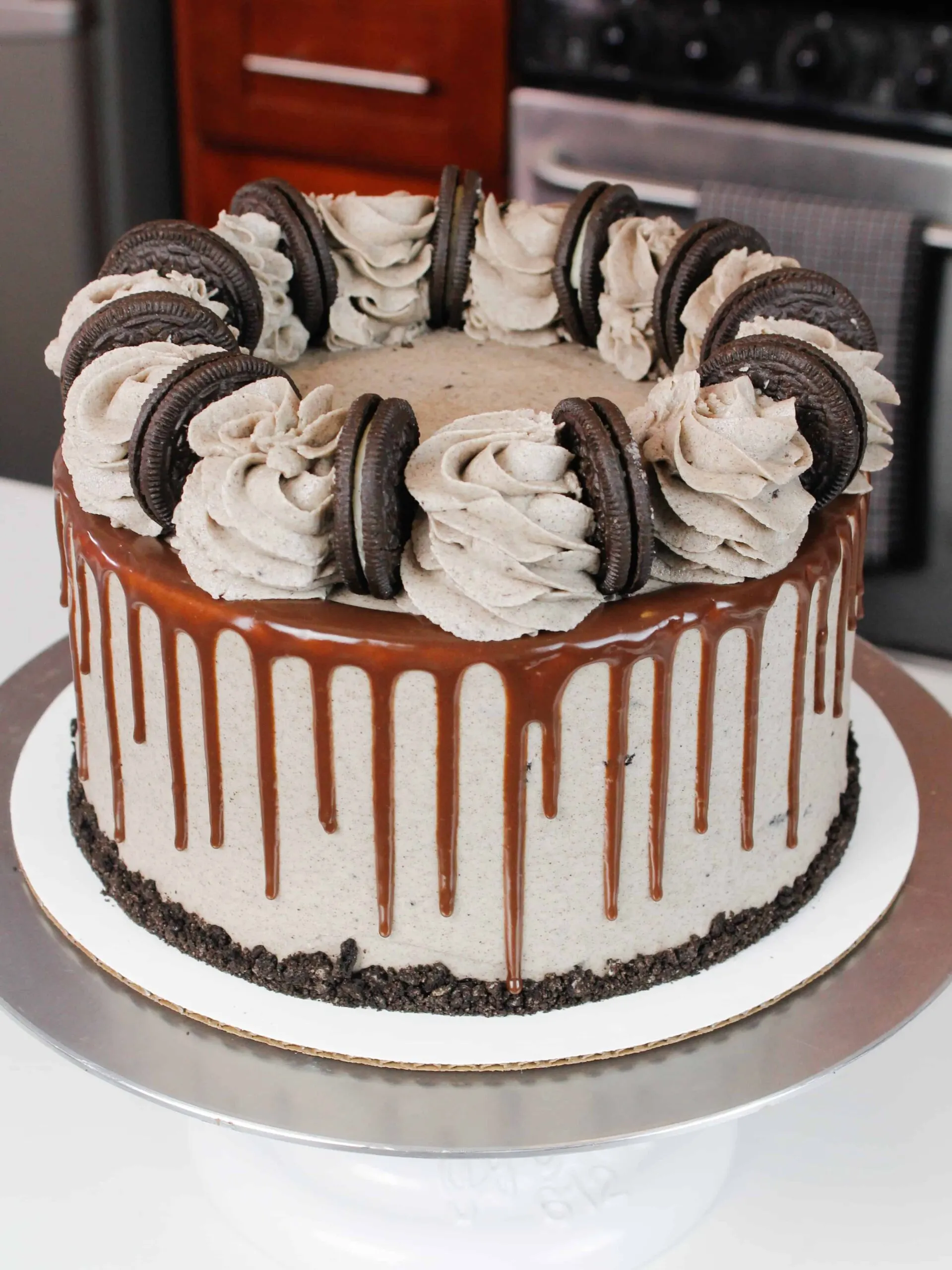 photo of oreo cake decorated with whole oreos and buttercream swirls