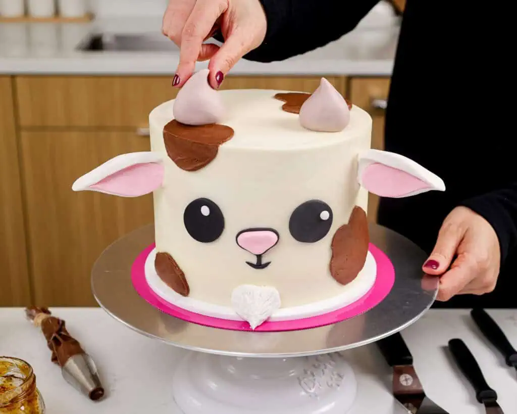 image of an adorable goat cake made with buttercream and a fondant face