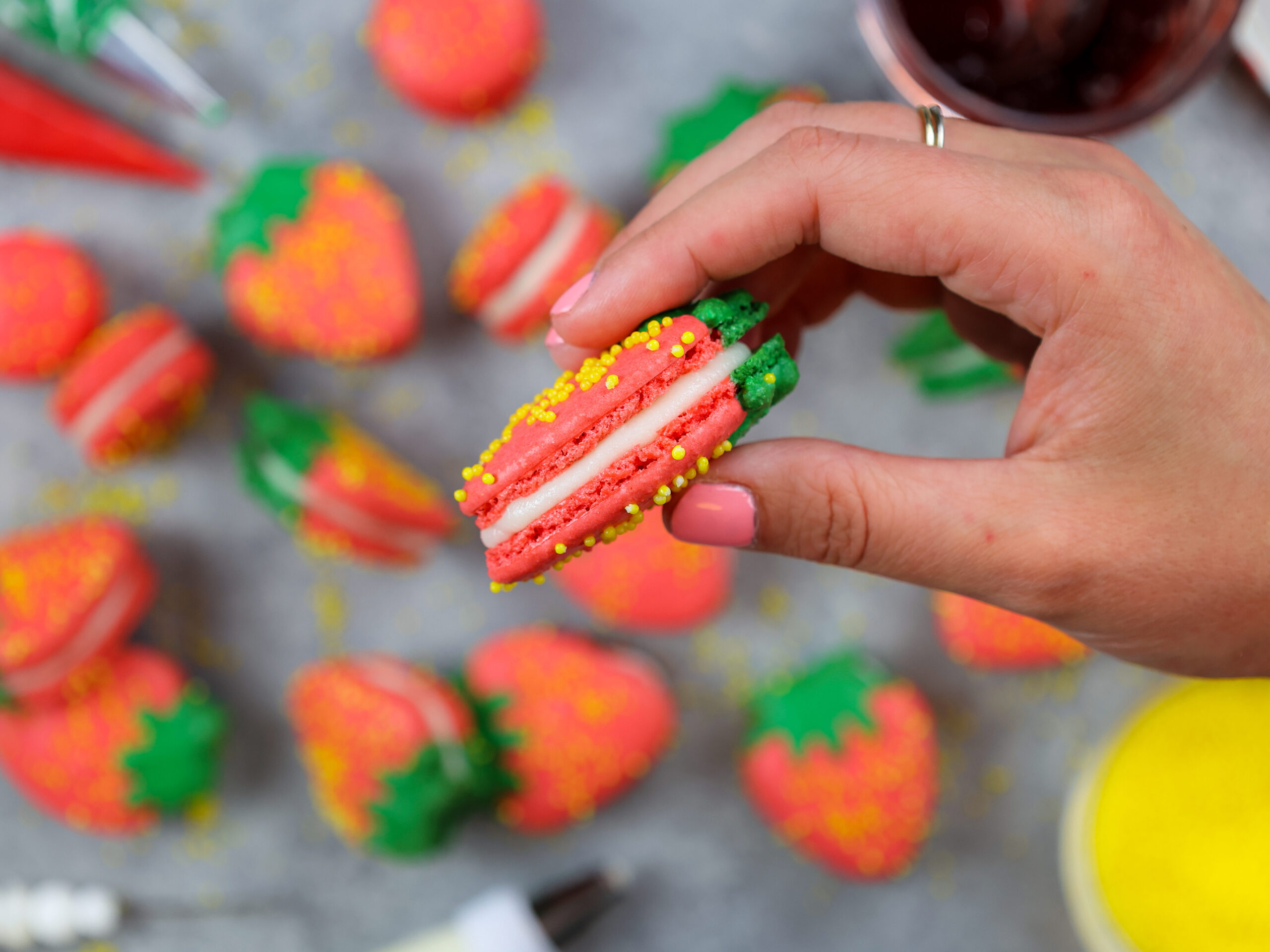 image of a strawberry macaron with perfect feet