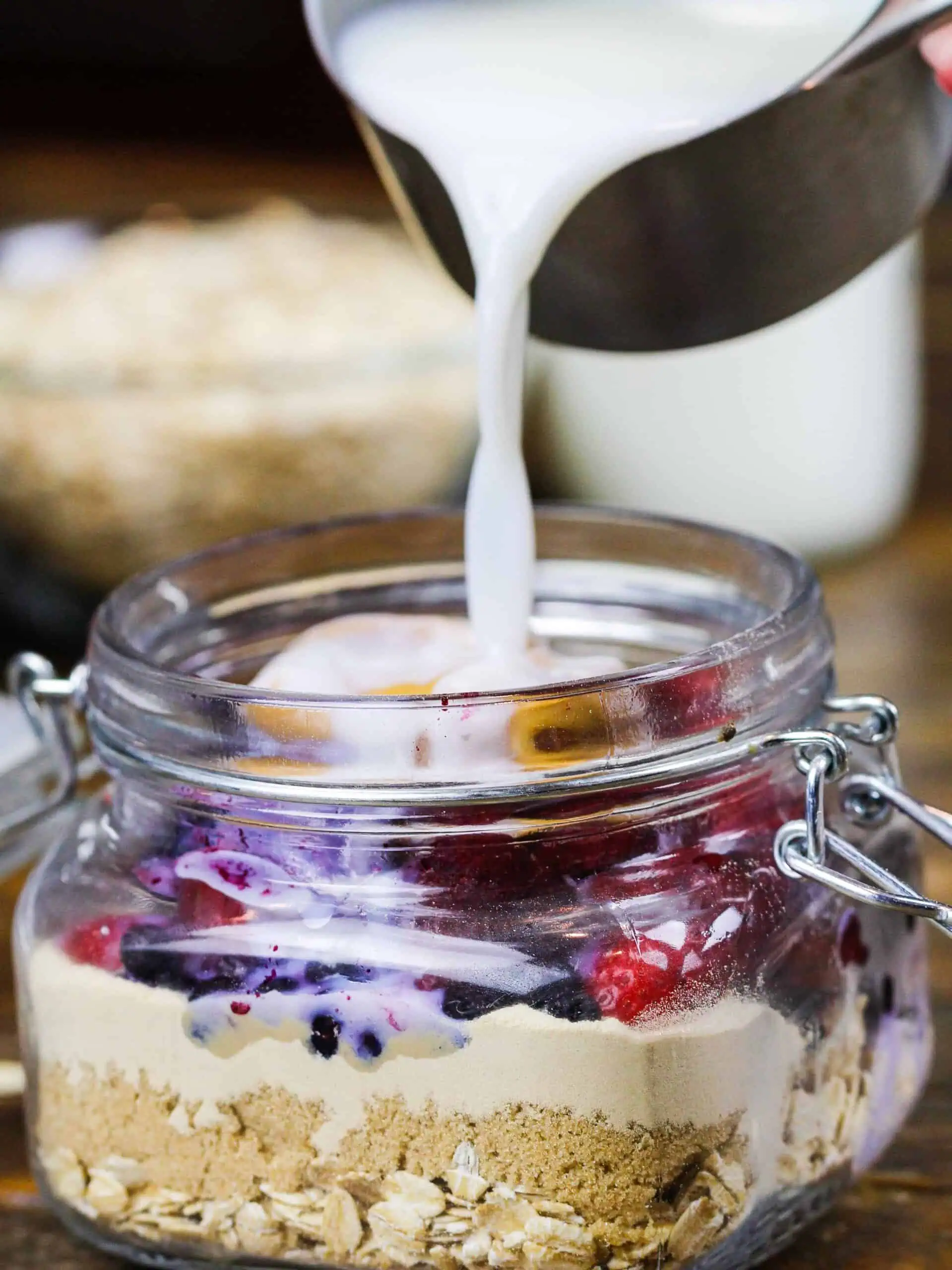 image of milk being poured into overnight oats made with protein powder