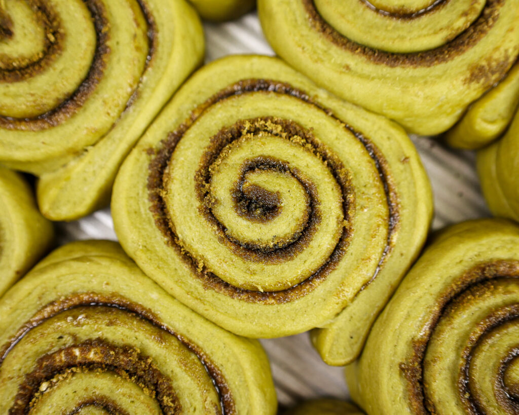 image of matcha cinnamon rolls that have been proofed and are ready to be baked
