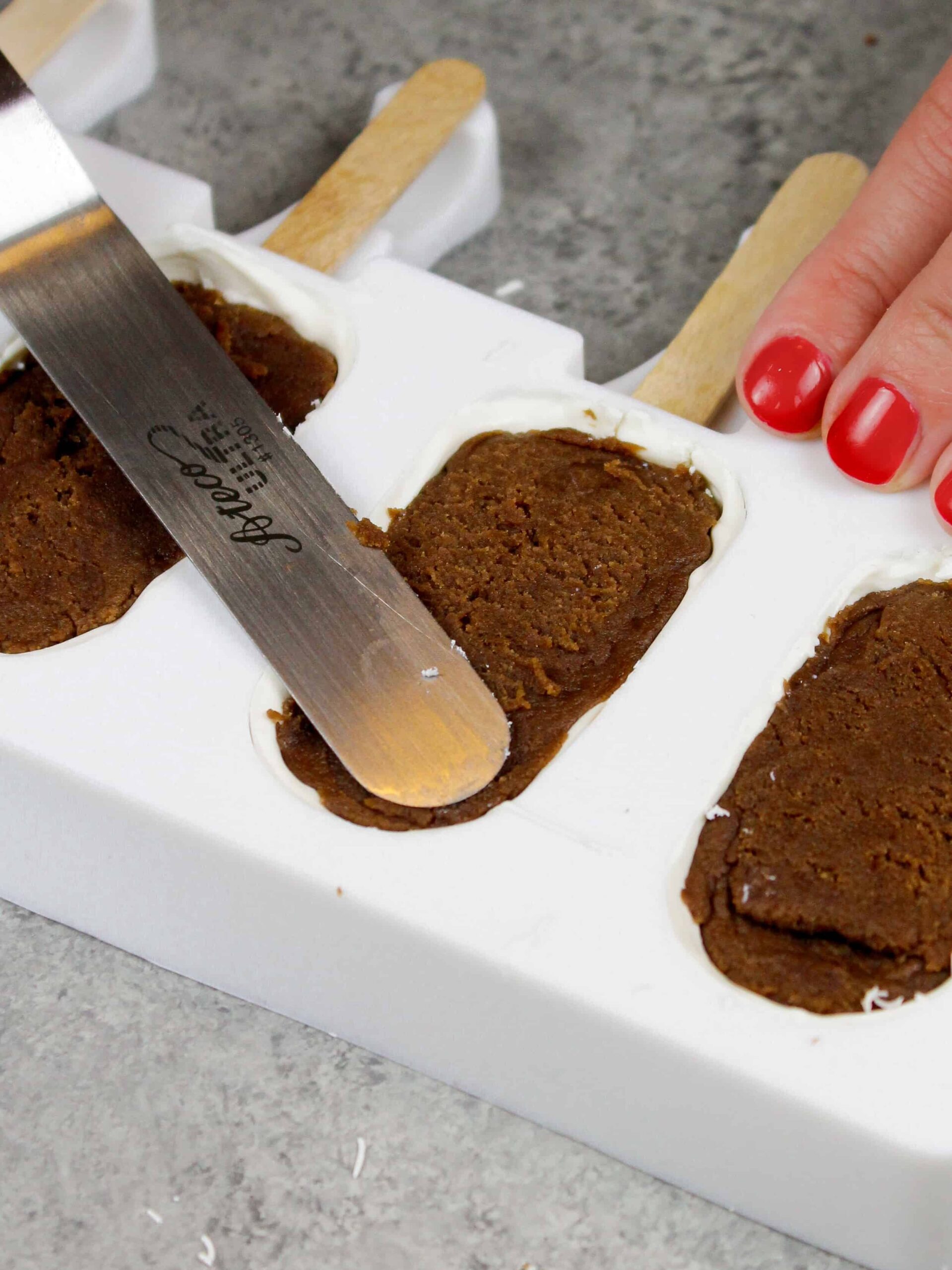 image of a silicone mold being filled with cake to make cakesicles or cake popsicles