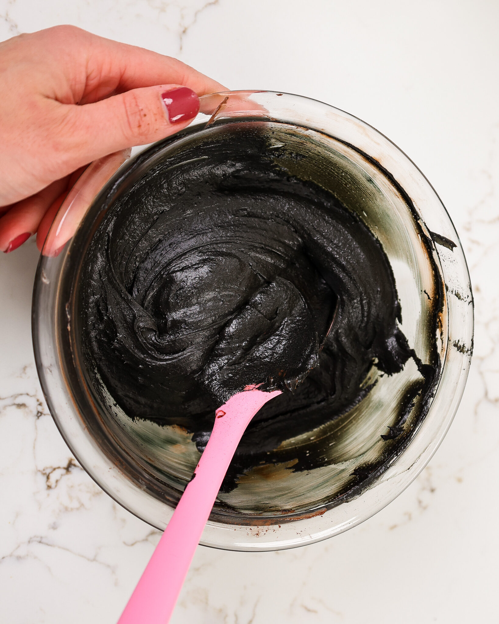 image of dark black buttercream in a bowl