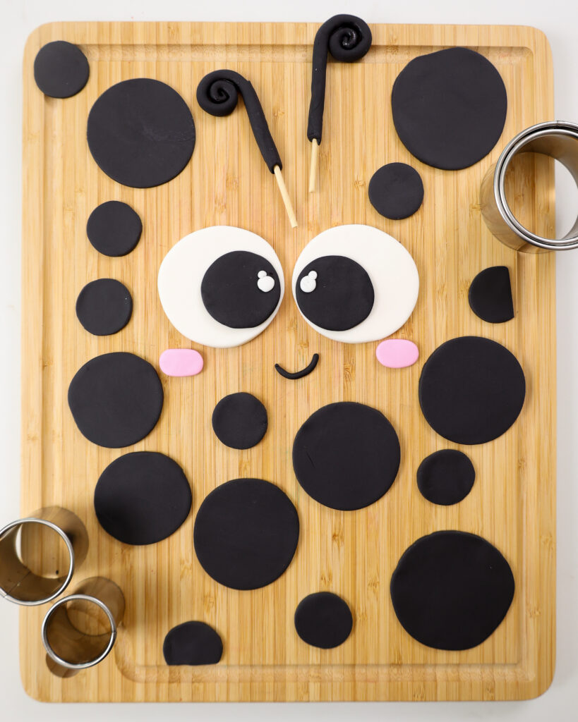 image of a fondant face that's been cut out for a lady bug cake