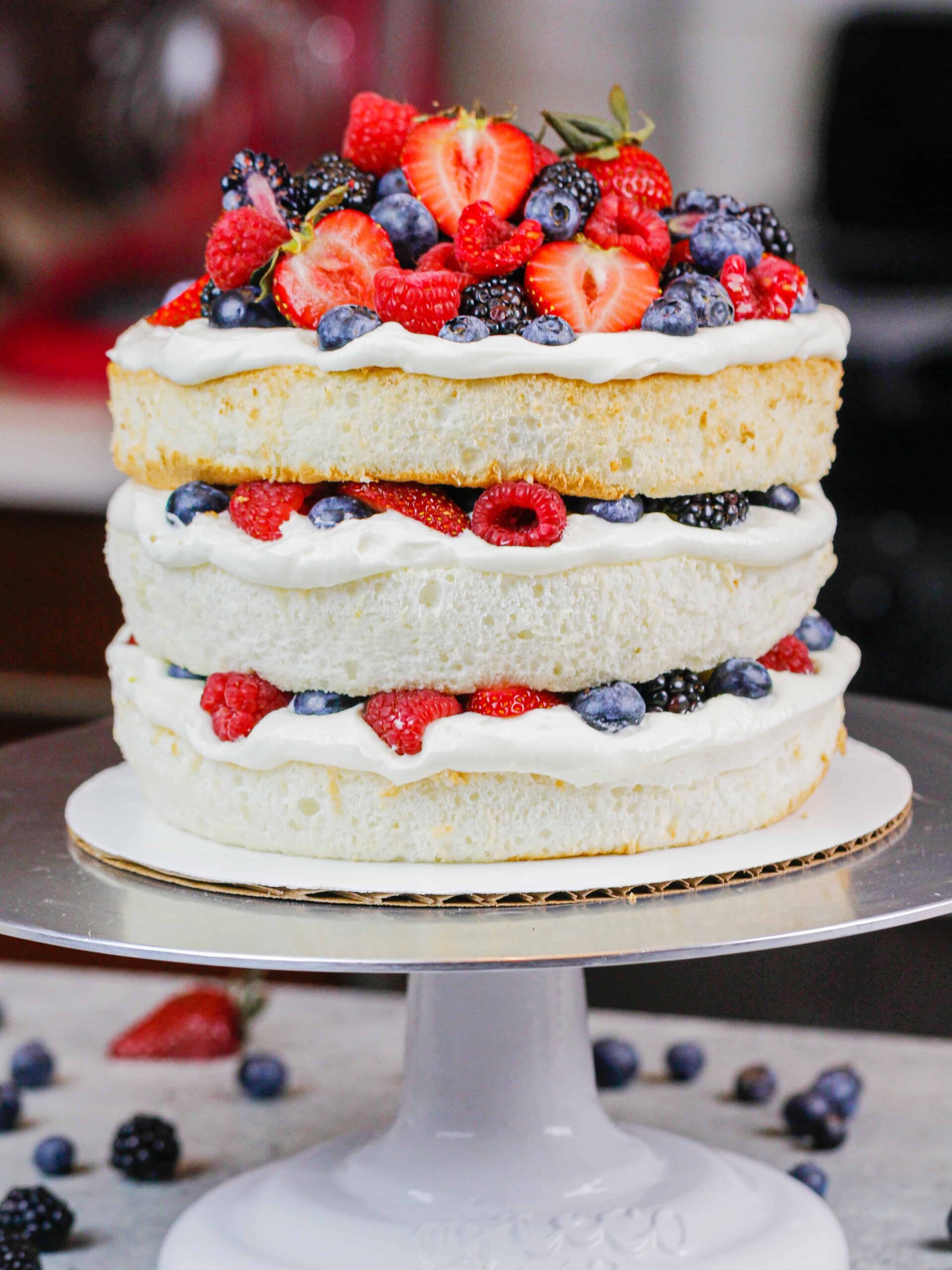 image of a layered angel food cake decorated with fresh berries
