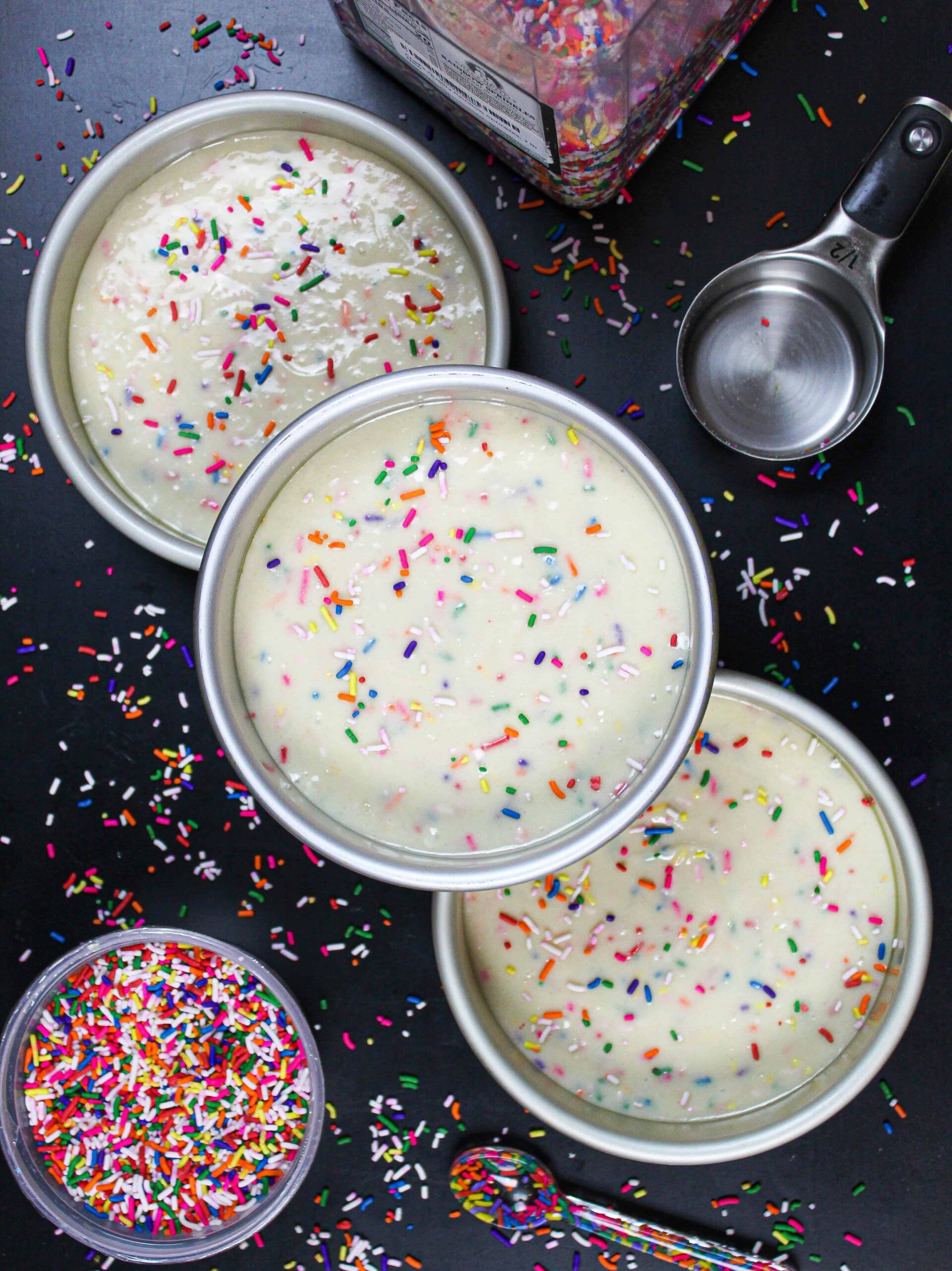 image of funfetti cake batter in 6 inch cake pans, ready to be baked