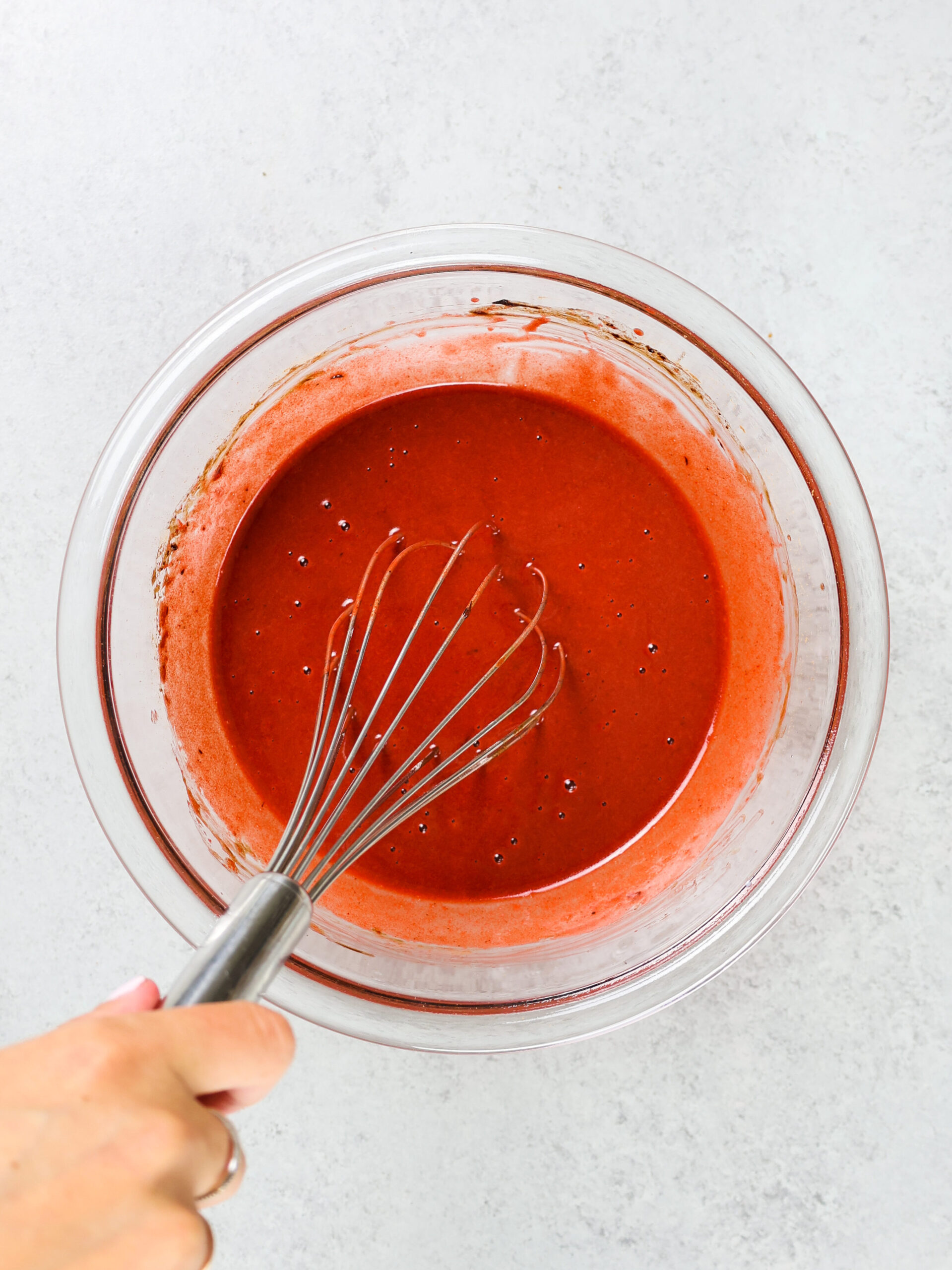 image of red velvet muffin batter being made with red gel food coloring