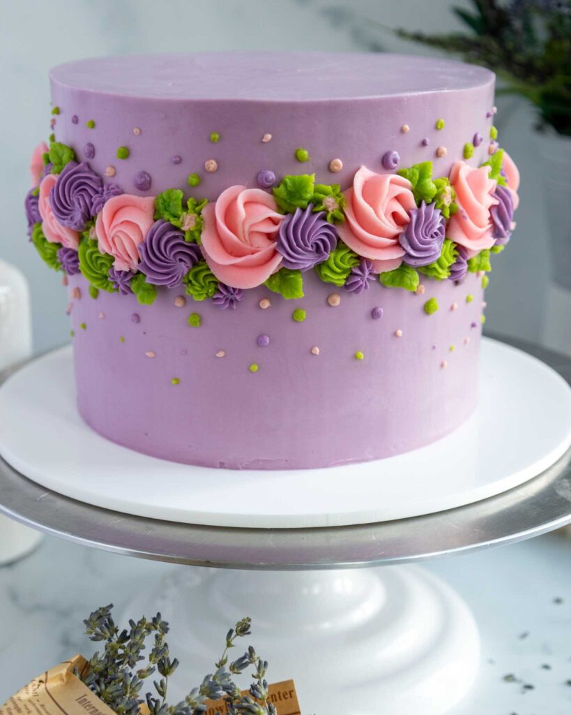 image of an earl grey lavender layer cake decorated with buttercream flowers