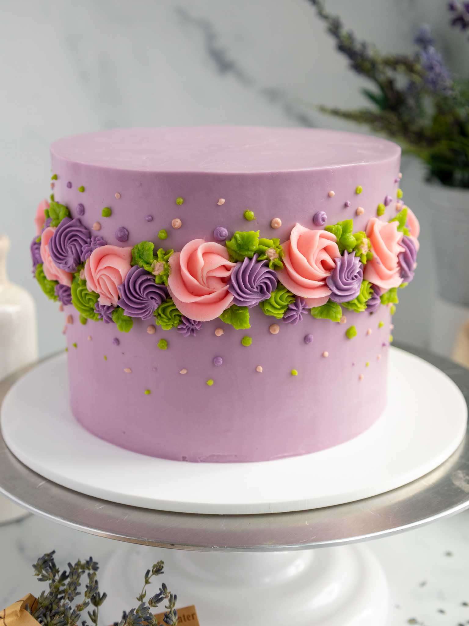 image of an earl grey lavender layer cake decorated with buttercream flowers