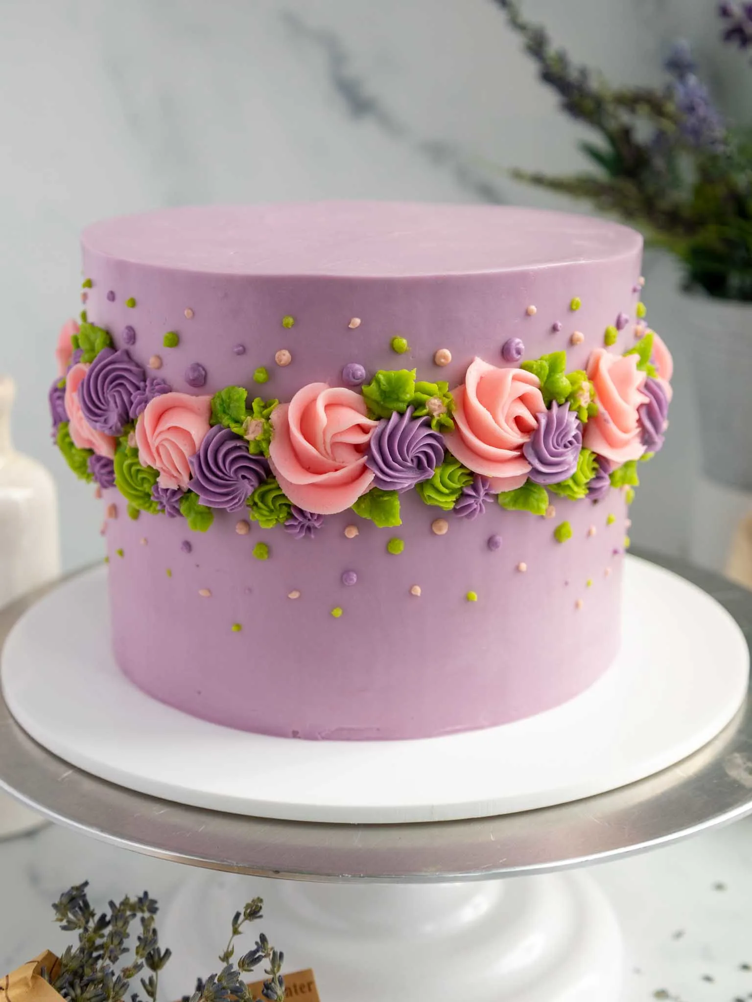image of an earl grey lavender layer cake decorated with buttercream flowers