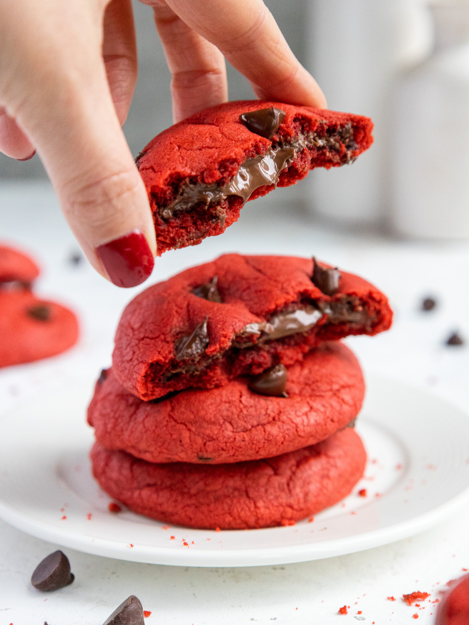 image of a red velvet Nutella cookie that's been bitten into to show the Nutella filling