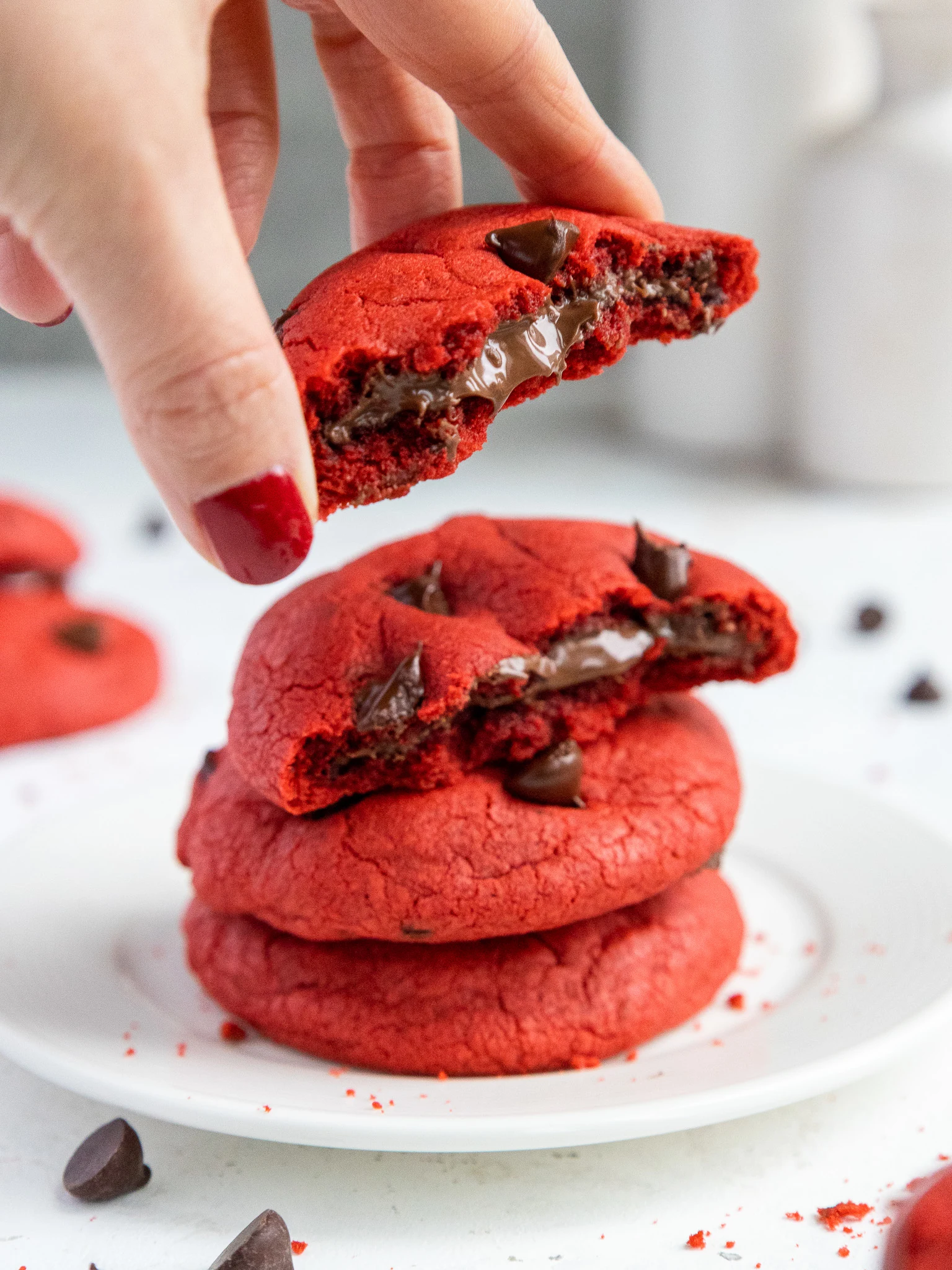 image of a red velvet Nutella cookie that's been bitten into to show the Nutella filling