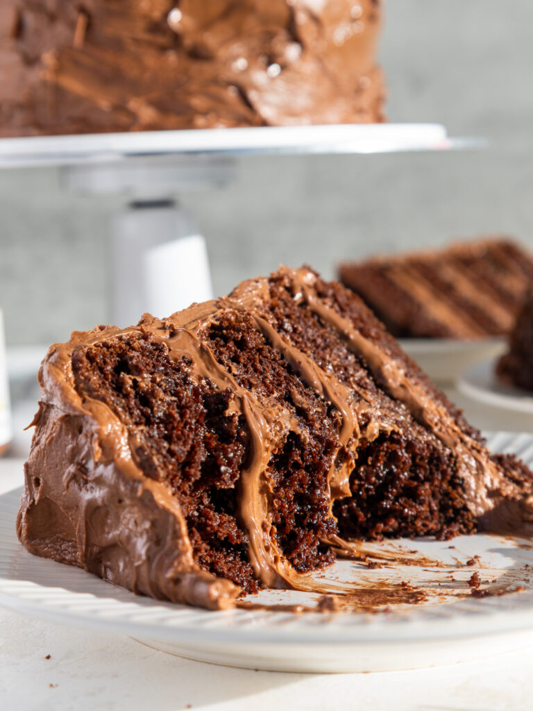 image of a slice of nutella cake on a plate that's been cut into to show its Nutella buttercream filling