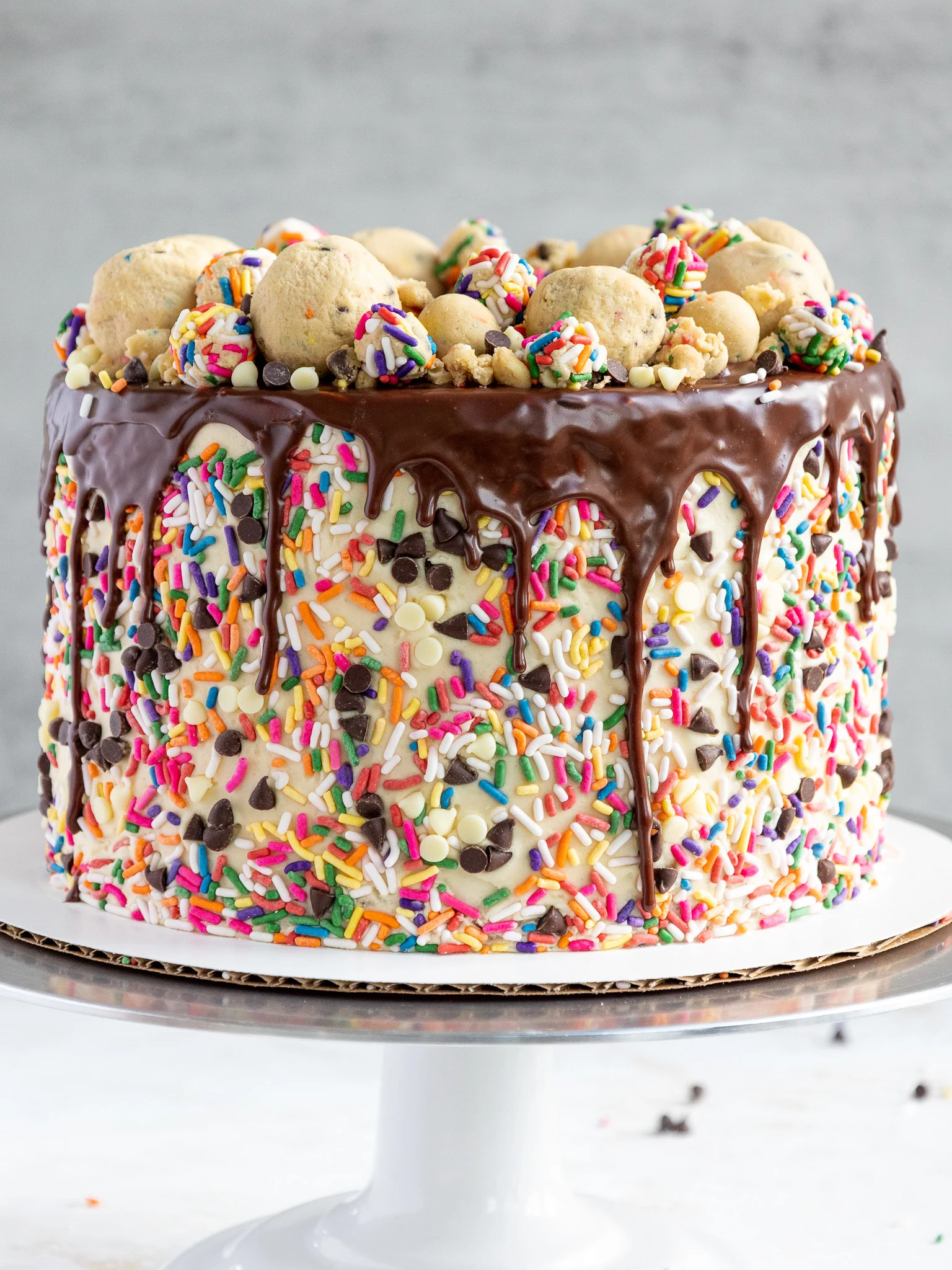 image of a cookie dough cake that's been decorated with edible cookie dough and sprinkles
