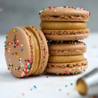 image of chocolate macaron shells that have been filled with peanut butter ganache
