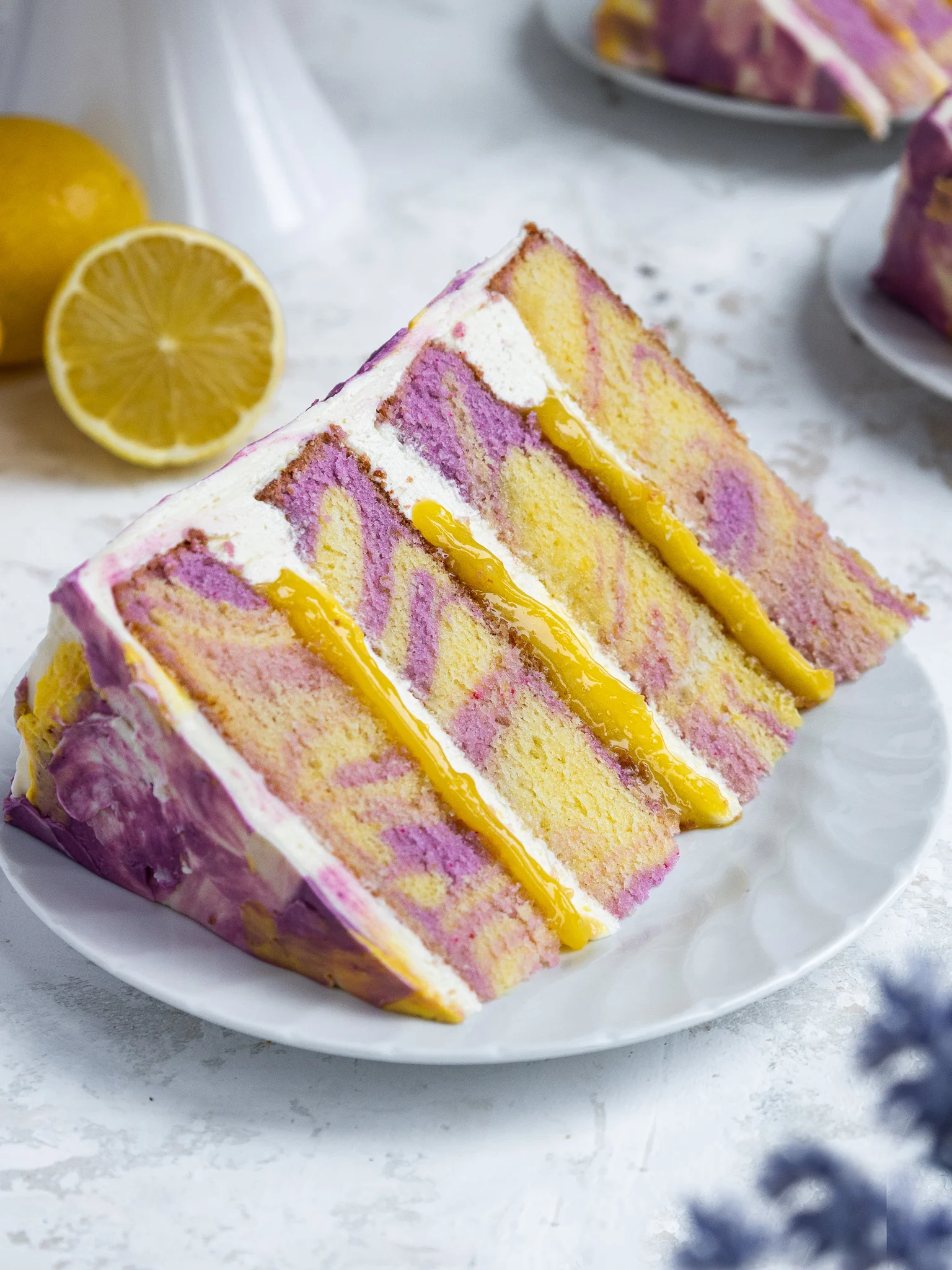 image of a slice of lemon lavender cake that's been placed on a plate