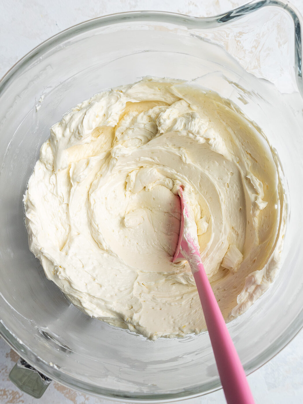 image of lavender swiss meringue buttercream that's been made in a large glass bowl