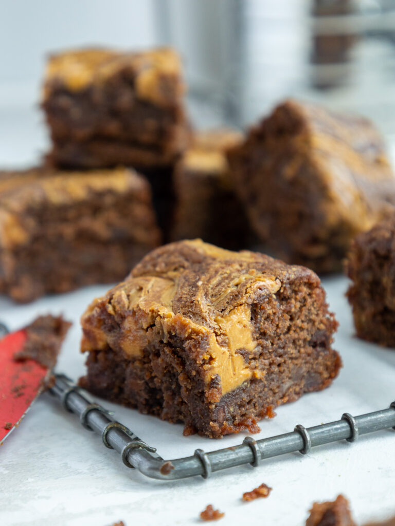 image of a fudgy banana peanut butter brownie that's had peanut butter swirled into the top of it
