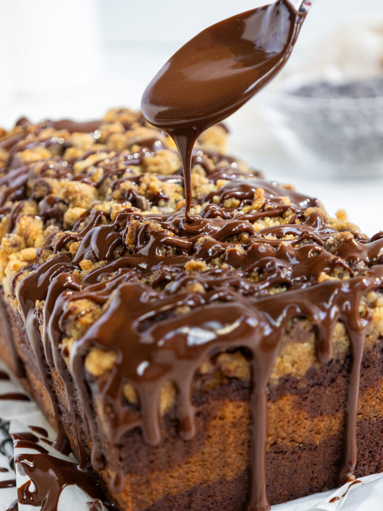 image of a marble banana bread bring drizzled with dark chocolate ganache