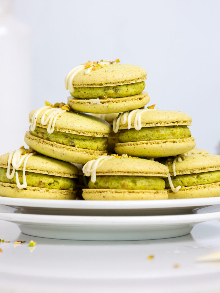image of pistachio macarons stacked on a small plate