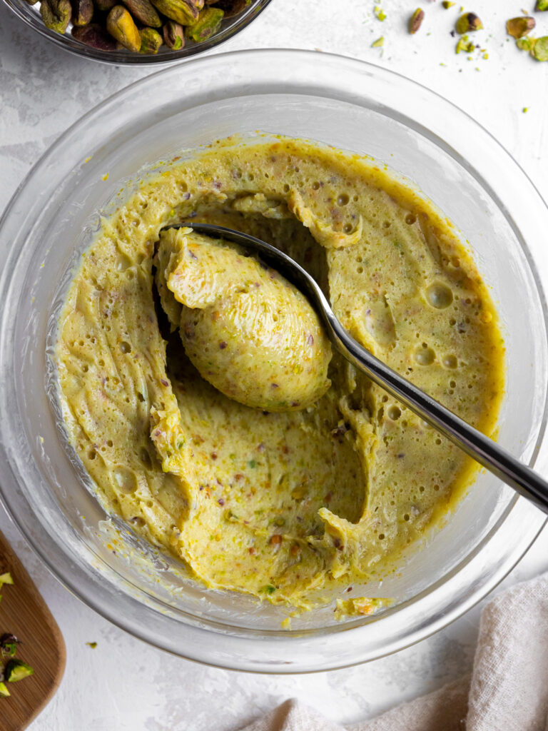 image of pistachio ganache that's been scooped with a spoon to show it's thick, pipeable consistency