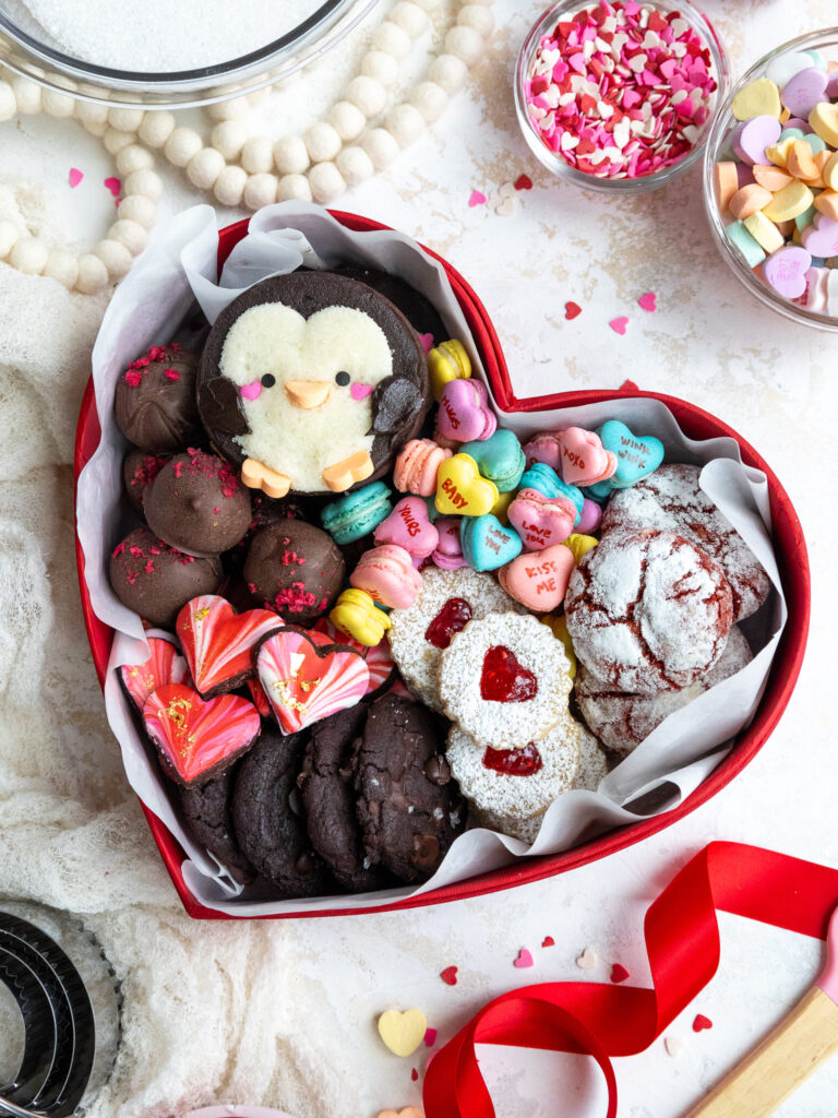 image of a cute valentine's day dessert box that's been filled with an assortment of cookies a truffles