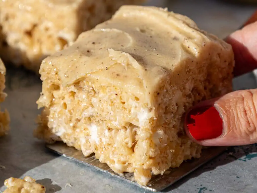 image of brown butter rice krispie treats being picked up